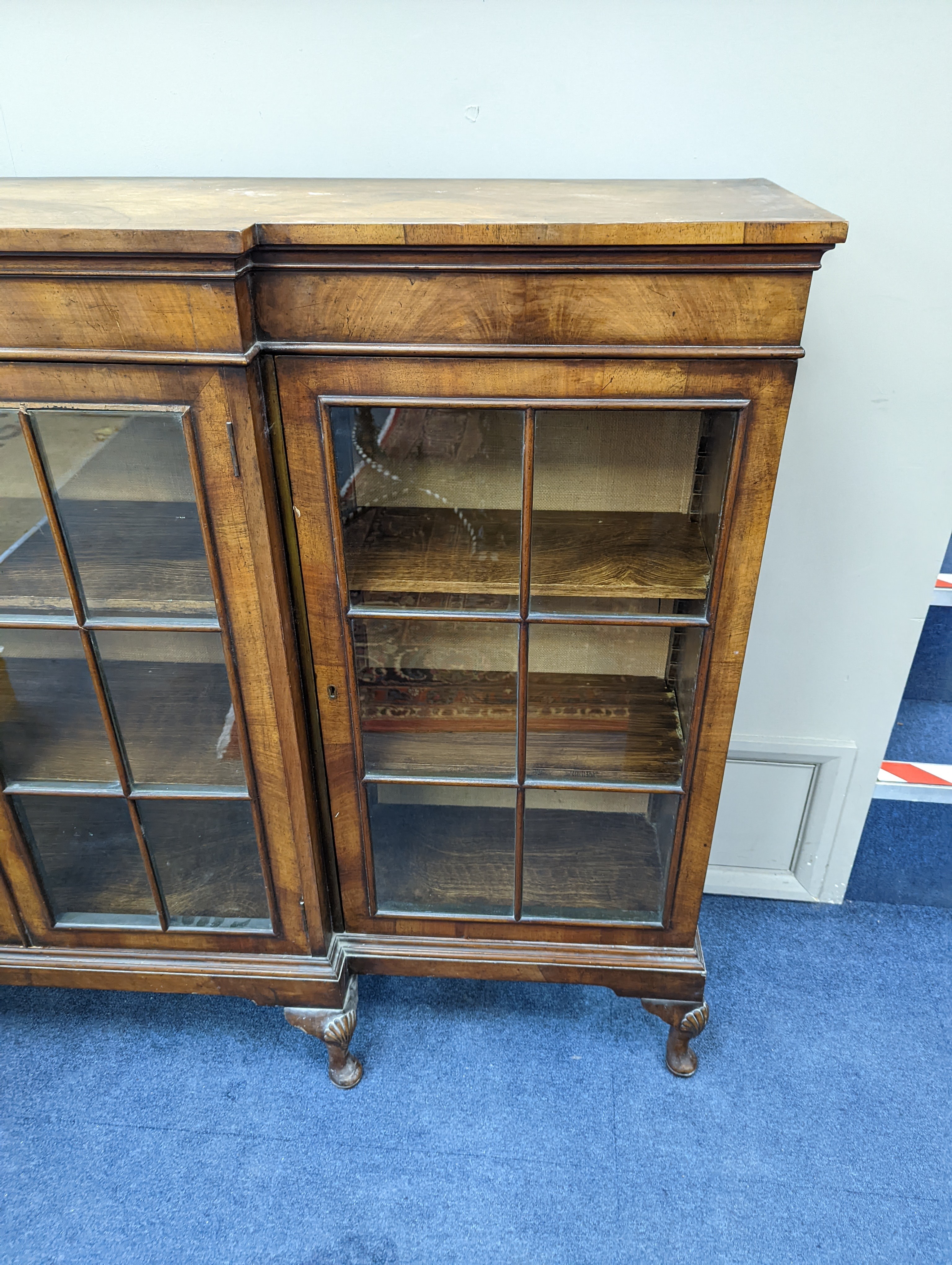 A Queen Anne revival walnut dwarf breakfront bookcase, length 182cm, depth 38cm, height 113cm